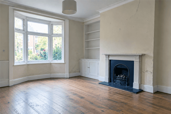 Living room with worn paintwork before redecoration